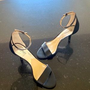 Michael by Michael Kors black heels with silver embellishment.